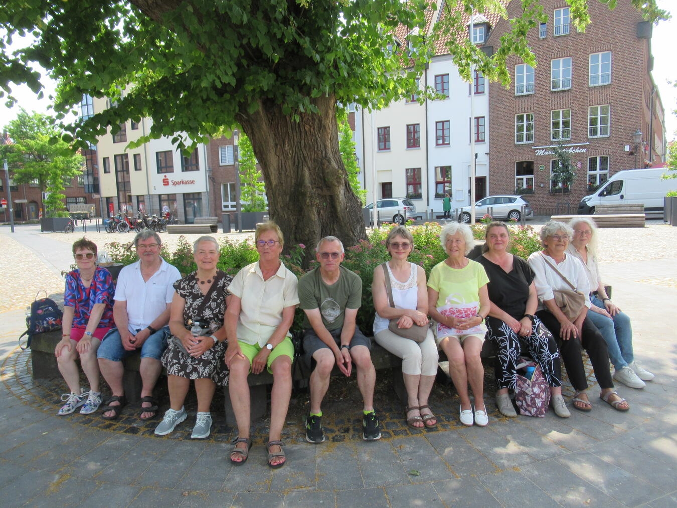 "Fröhliche Menschen feiern das Jubiläum des TTC Kellen, Gruppenfoto bei sonnigem Wetter"