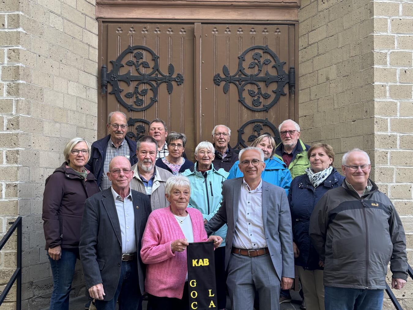 KAB GocherLand mit neuem Wimpel Anne und Gerd Barten, Dirk Wagner und fast alle Vorstands- und Vertrauensleute der KAB-Gemeinschaft freuen sich über den neuen Wimpel. Foto: Volksbank an der Niers