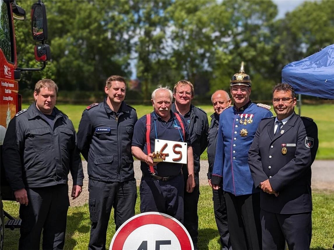 Ausbilder Thomas Verbeet (2.v.r.) übergab in historischer Uniform ein Präsent der Reeser Feuerwehr an Paul Kortenhorn (3.v.l.). Foto: Feuerwehr Rees