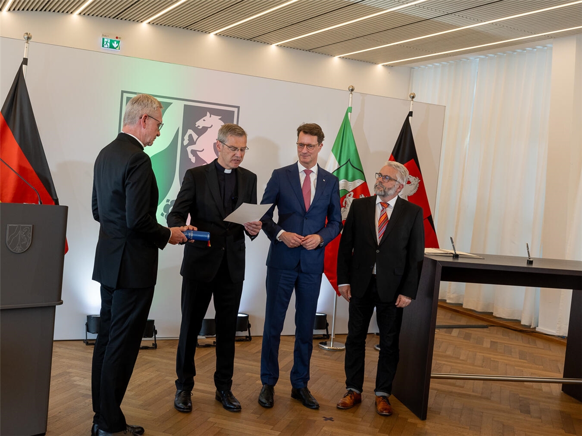 Bischof Dr. Heiner Wilmer legt Treueeid ab, neben NRW-Ministerpräsident Hendrik Wüst und Regierungsvertretern.