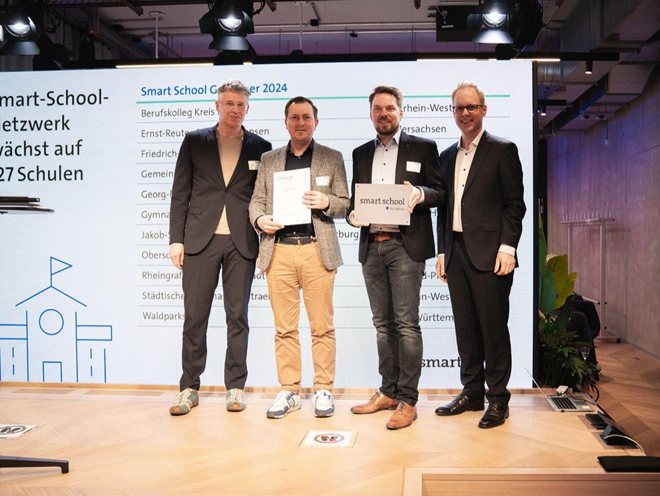 Bitkom-Hauptgeschäftsführer Dr. Bernhard Rohleder, Lehrer Steffen A. Schmidt, Lehrer Dr. Johannes Hellenbrand und Staatssekretär des Bundesministeriums für Bildung und Forschung Dr. Jens Brandenburg (v.l.). Foto: Martin Klemmer/Bitkom e.V.