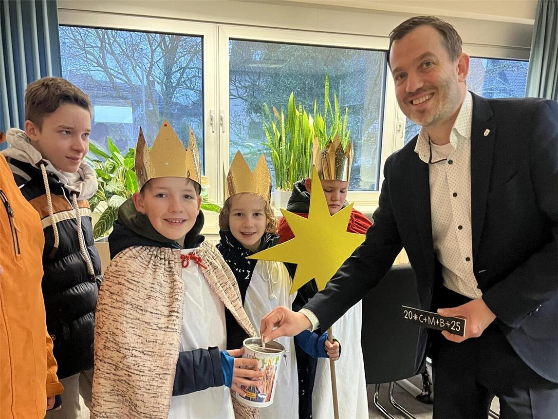 Bürgermeister Bernd Kuse bedankte sich bei den Sternsingern Torben, Noah, Elias und Hannes für ihren Einsatz. Foto: Stadt Straelen