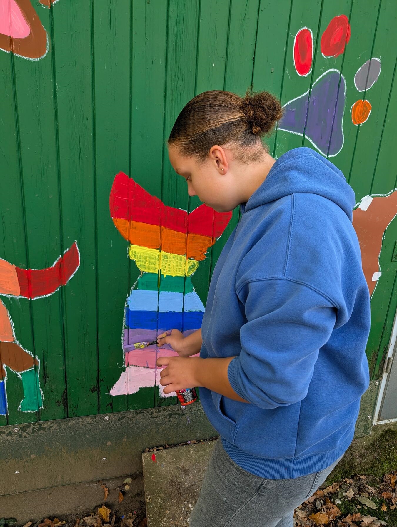 Chihuahua mit buntem Regenbogenmuster auf dem Fell, farbenfrohes Hundebild
