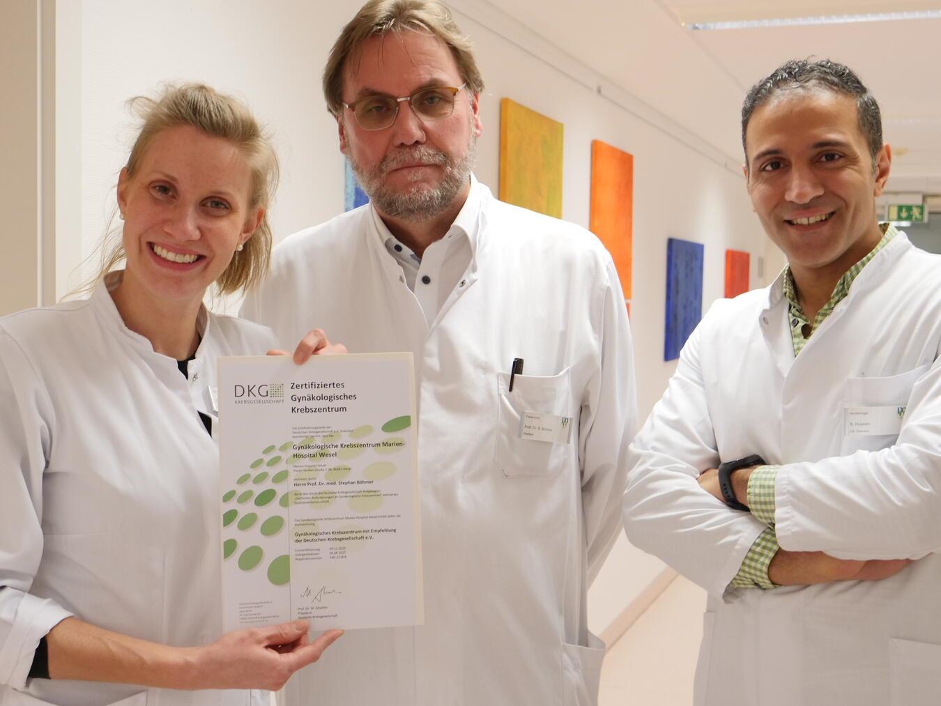 Präzisions-Chirurgie in der gynäkologischen Onkologie Chefarzt Prof. Dr. Stephan Böhmer (m.), der leitende Oberarzt Dr. Shady Hussein und Oberärztin Dr. Wiebke Schmuck, Koordinatorin des Zentrums, mit dem Zertifikat der Deutschen Krebsgesellschaft. Foto: Marienshopital Wesel