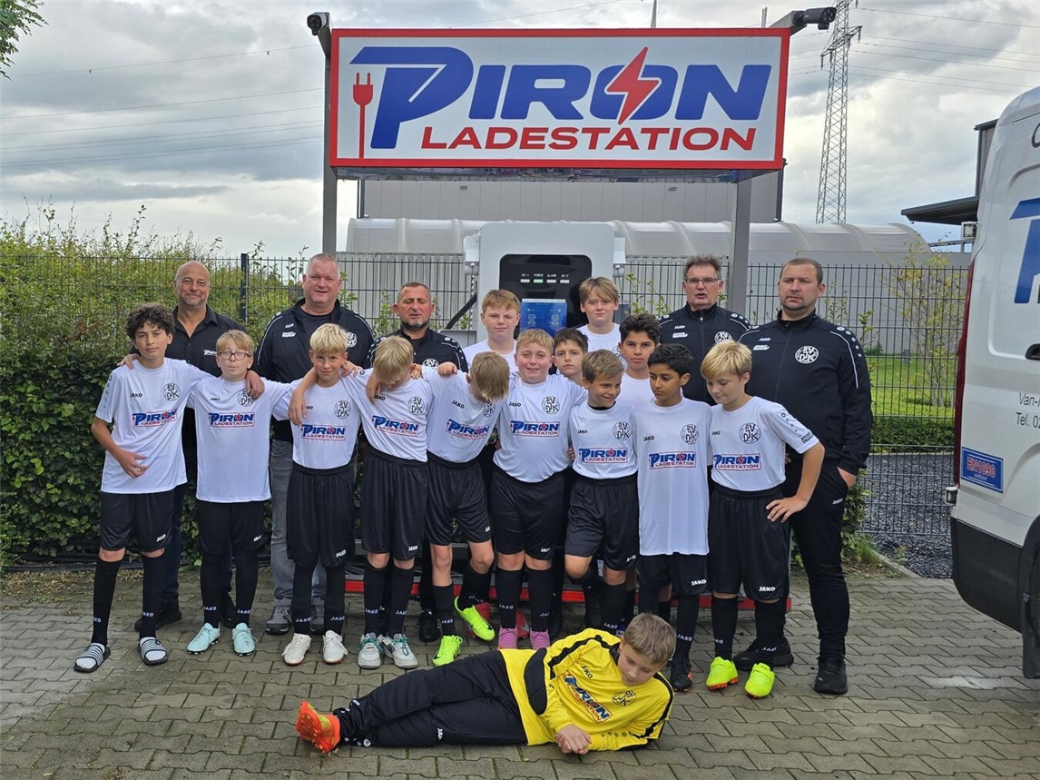 Die D1-Junioren des BV DJK Kellen mit ihrem neuen Trikotsatz, überreicht von Sascha Piron (Piron Metallbau GmbH), zusammen mit Trainern und Helfern. Foto: Piron
