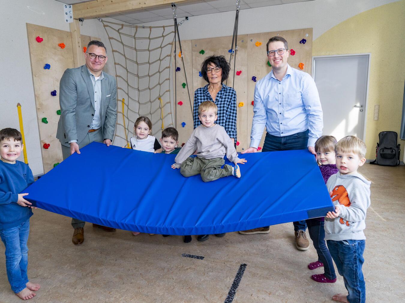 Die Kinder der St. Lucia KiTa mit (v.l.n.r.) Volksbank-Geschäftsstellenleiter Björn Pusnik, KiTa-Leitung Gerda Aben und den 1. Vorsitzenden des Fördervereins, Andreas Well. Foto: Gerhard Seybert