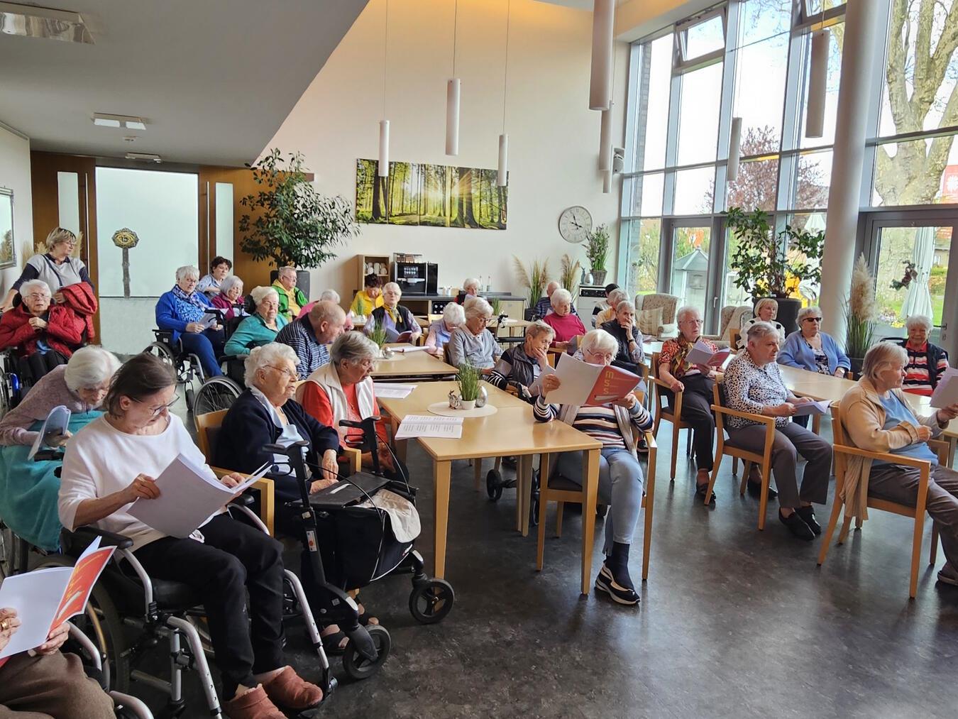 Die Senioren im Marien-Haus Straelen singen begeistert beim Konzert des Mundharmonika-Orchesters mit.