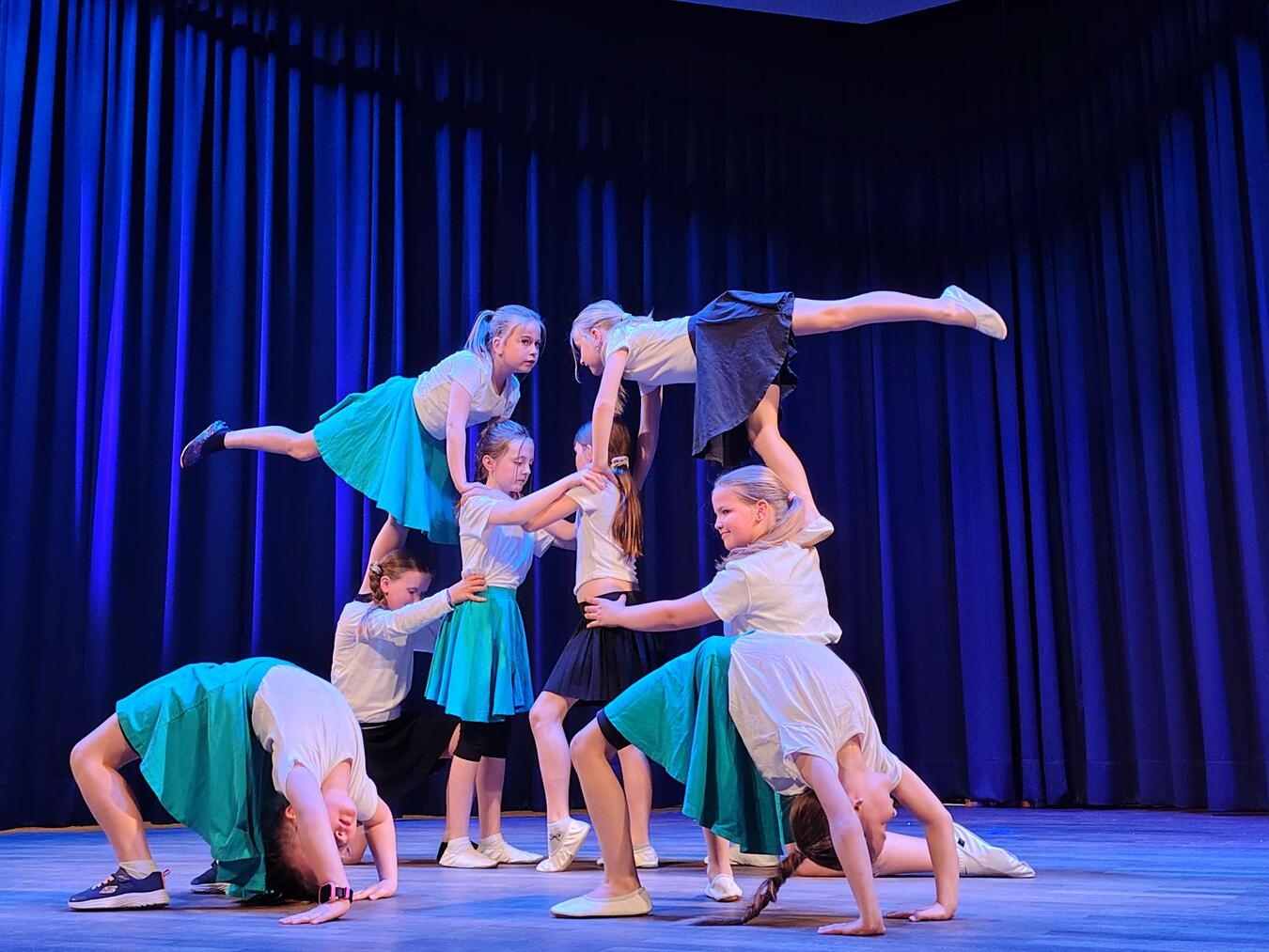 "Wilde Hopser tanzen Hip-Hop in bunter Kleidung, Energie und Spaß auf der Bühne, Tanzgruppe Performance"