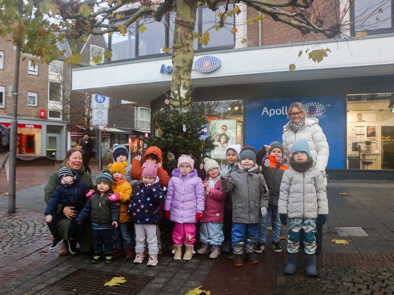 Eine der Kitas, die sich an der Tannenbaum-Schmückaktion beteiligte, war die Gelderner Kita St. Michael – sie schmückte den Tannenbaum vor Apollo am Drachenbrunnen. Mit im Bild: Organisatorin Carmen Eichler (hinten rechts) vom städtischen Tourismus- und Kulturbüro.Foto: Caritas/Deckers
