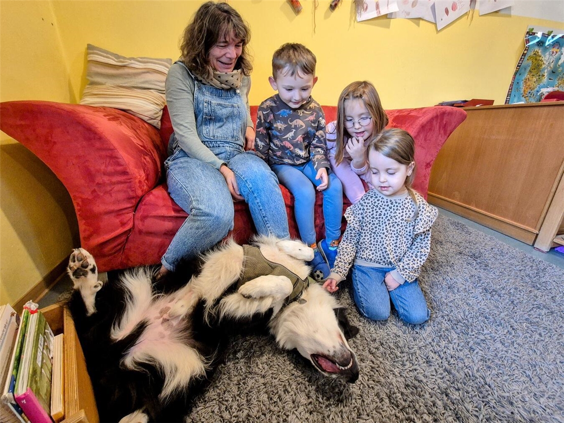 Elke Priebe, Leo, Merle und Hannah genießen eine entspannte Kuschelzeit mit Begleithund Knut – Lernen mit Herz und Fell. Foto: DRK