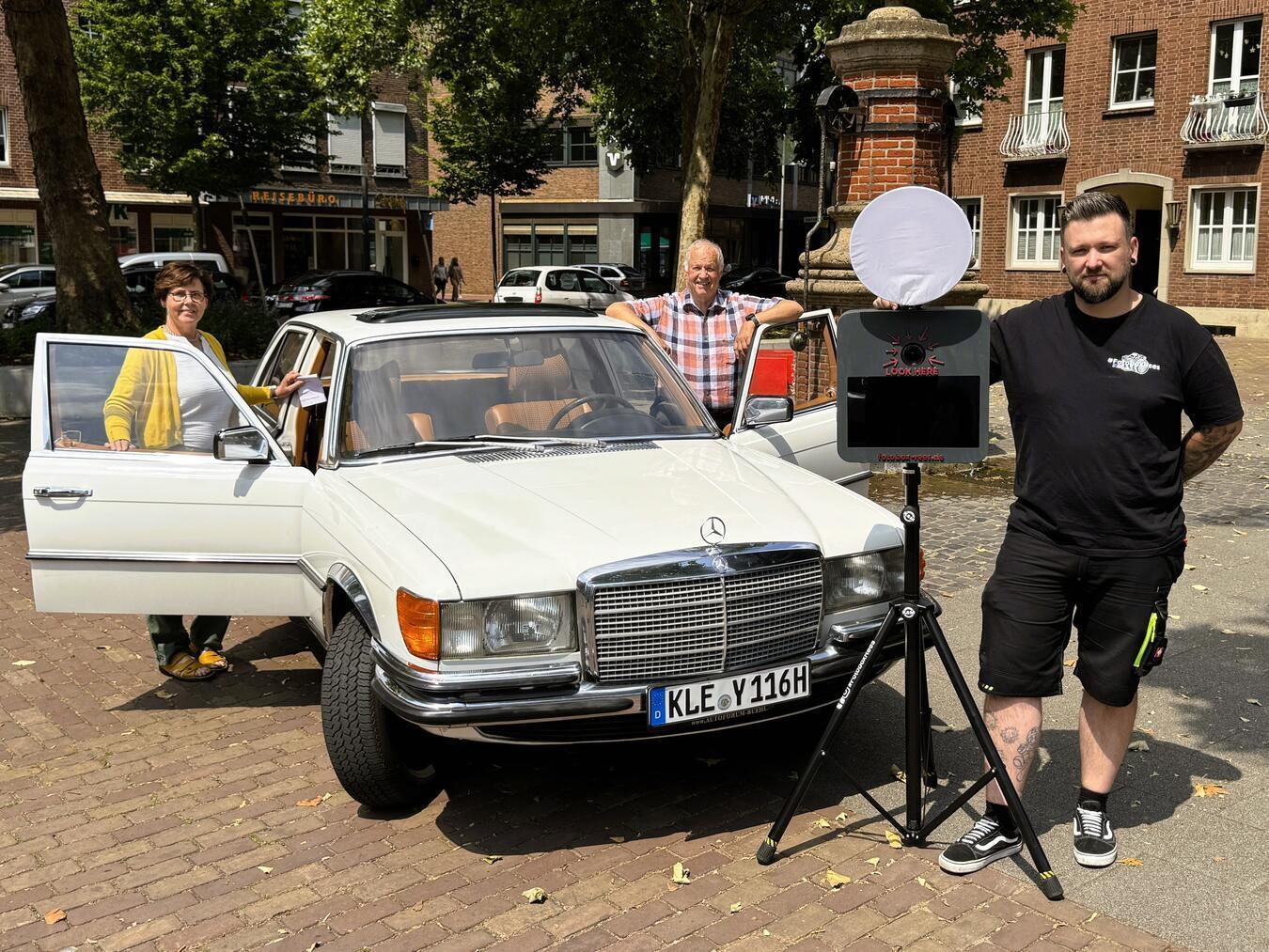 Fotos für den guten Zweck: (v. l.) Riccarda Leidenfrost (Stadt Rees), Karl Hagedorn (Oldtimer-Besitzer) und Mario Hensel (Fotobox Rees). Foto: Stadt Rees