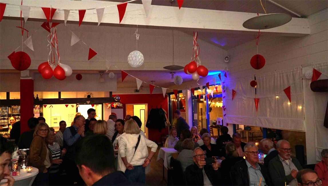 "Feier im Clubhaus Jahnstraße, fröhliche Gäste tanzen und genießen die Party"