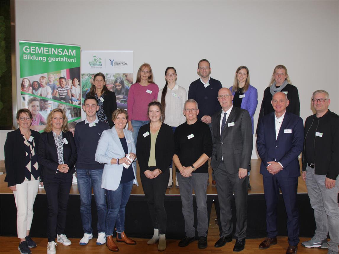 Landrat Christoph Gerwers (vorne 3. v.r.), Dagmar Wintjens (vorne l.) sowie Zandra Boxnick (vorne 2.v.l.) und Moderatorin Andrea Franken (vorne 4.v.l.) mit den Aktiven der Bildungskonferenz 2024.Foto: Kreis Kleve
