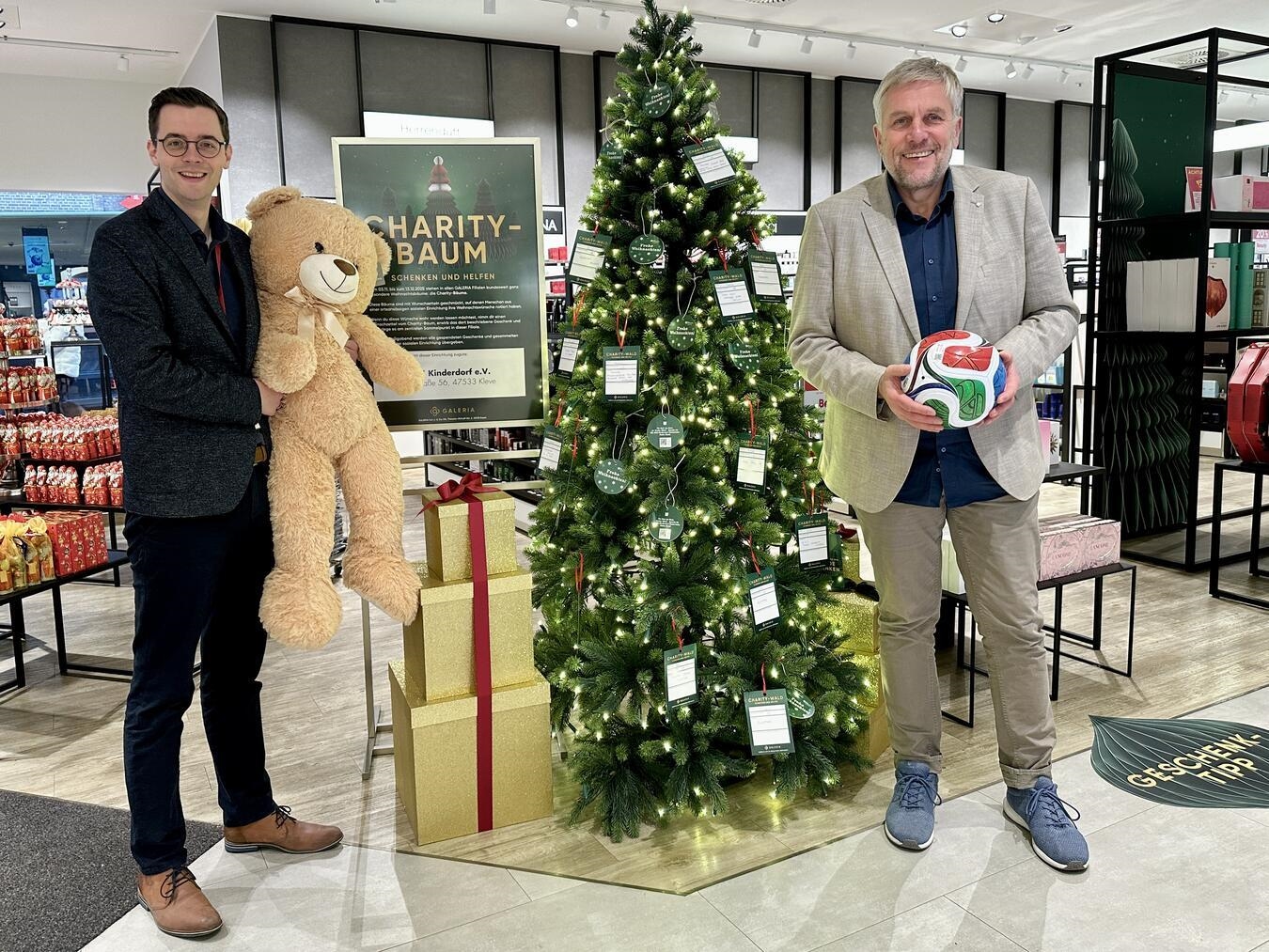 Mathijs Driessen, Geschäftsführer Galeria Kleve, und Peter Schönrock, Einrichtungsleiter SOS-Kinderdorf Niederrhein, freuen sich über die Wunschbaum-Aktion in der Klever Innenstadt. Foto: SOS-Kinderdorf Niederrhein/Katrin Wißen