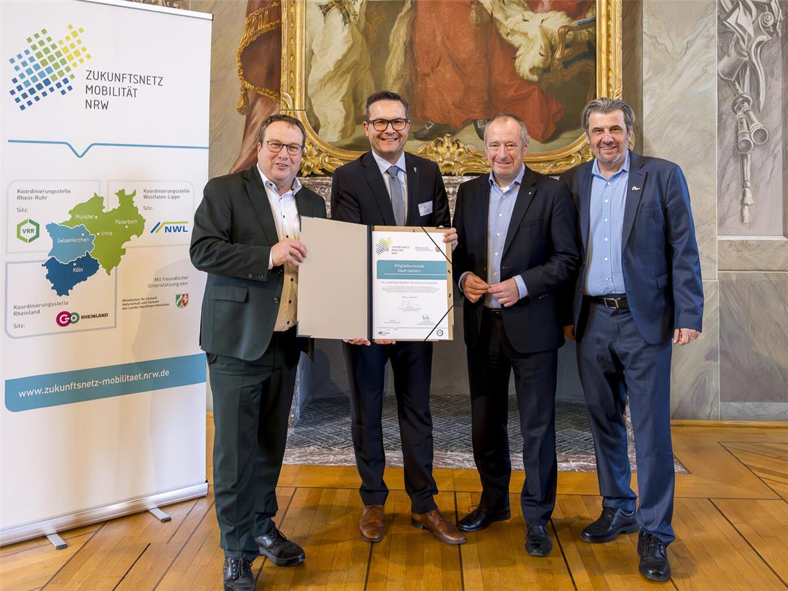NRW-Verkehrsminister Oliver Krischer (l.) übergibt der Stadt Geldern die Urkunde zum Beitritt zum Zukunftsnetz Mobilität NRW.Foto: go.Rheinland GmbH/Smilla Dankert