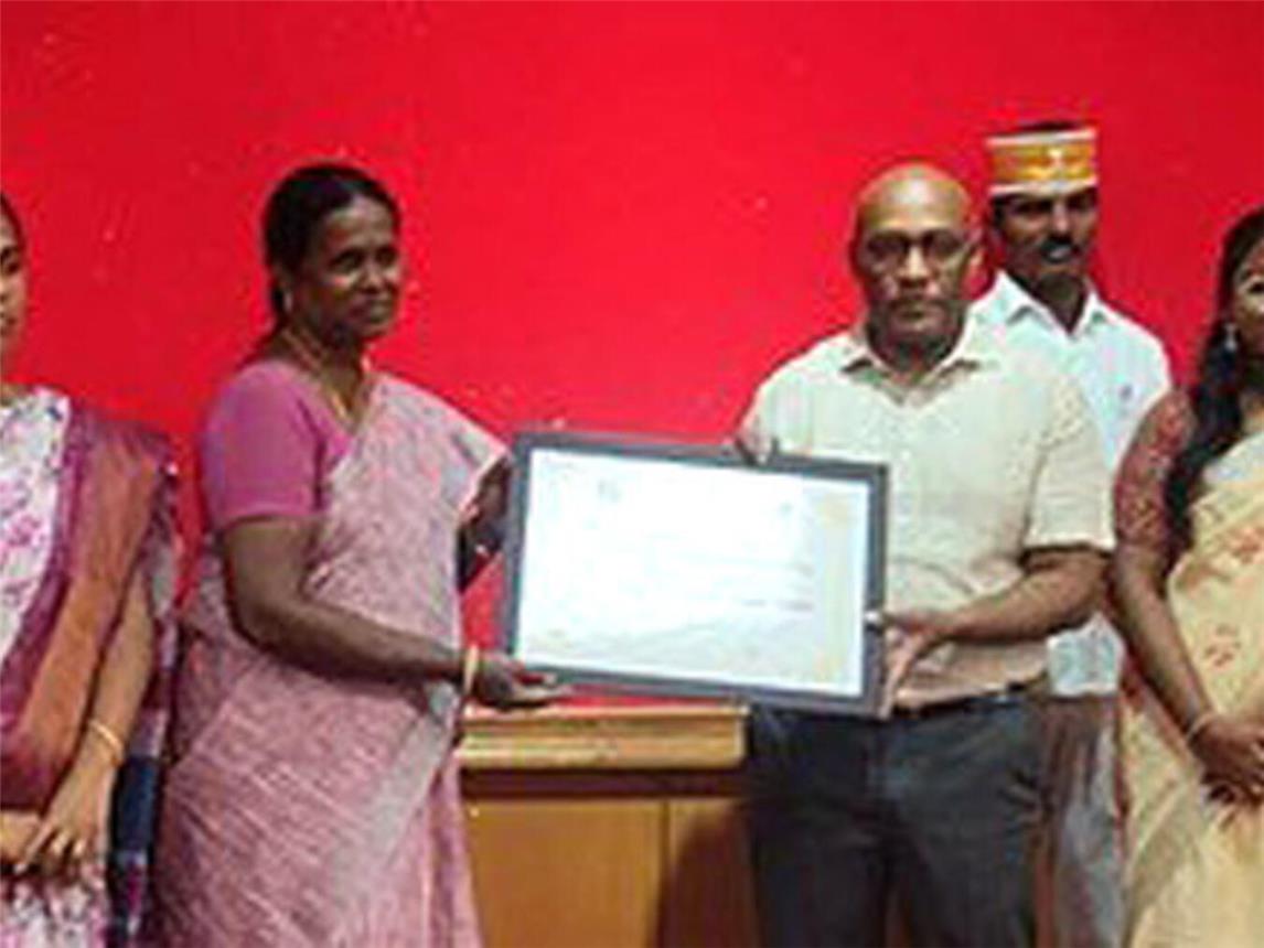 Vertreter der Regierung Tamil Naidoo überreichen den beiden Leiterinnen des Karunai-Kinderhauses die Urkunde.